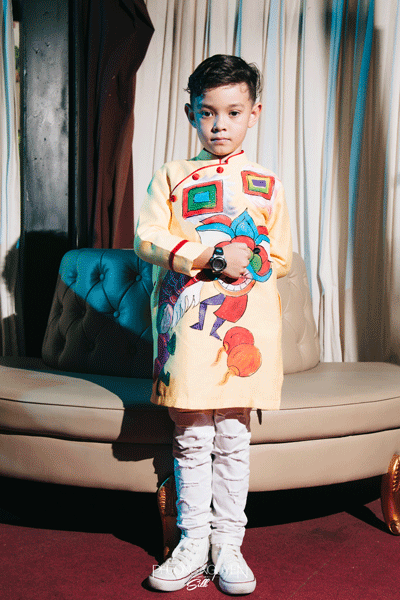 柄の入った黄色系アオザイを着たベトナム人の子供
