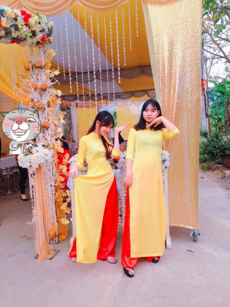 黄色のアオザイを着ているベトナム人女性